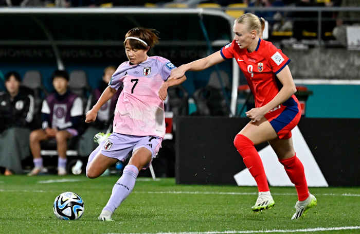 Japan's Hinata Miyazawa kicks the bowl with Karina Saevik of Norway defending her during the round of 16 at the Women's World Cup.